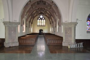 Wooden pews inside of an old church