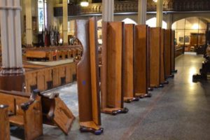 Church pews laying on their side before they are installed