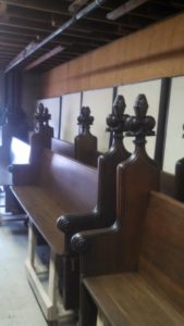 Completed wooden church pews that haven't been installed yet