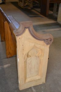 Side angle of an old church pew before it's refinished
