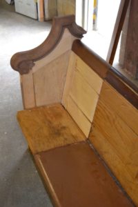 Broken wooden pew before it's refinished