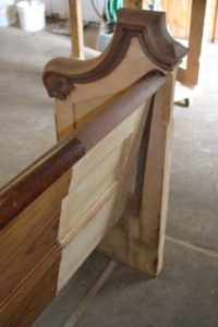 The back of a broken church pew before it's refinished