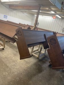 Dark wood sage chapel pews getting refinished