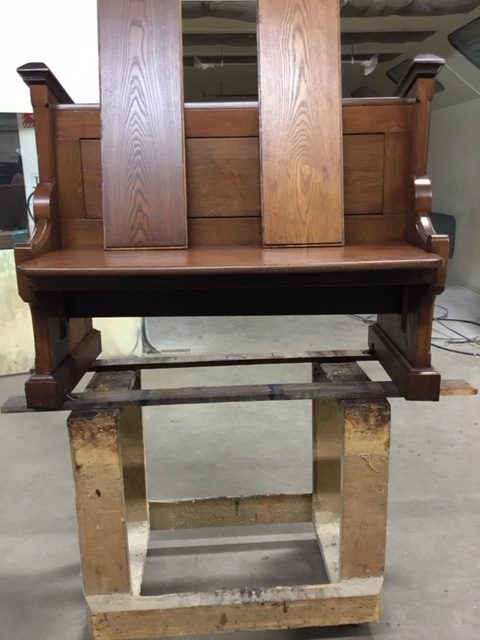 Refinishing pews in Our Lady of Grace Church