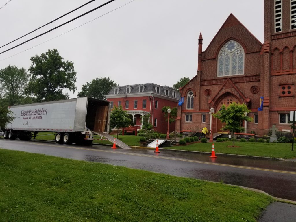 keck group truck outside of a brick church in the rain