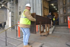 Carrying church pews to take inside St. Patrick's Cathedral to preserve history