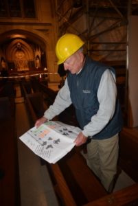 Looking over map plans for church pews inside St. Patrick's Cathedral to preserve history