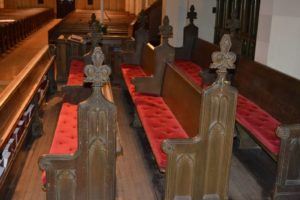 Finished church pews with red cushion seats