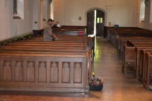 Wooden pews being installed in a church