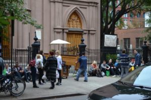 Groups of people outside a church while pews are being installed