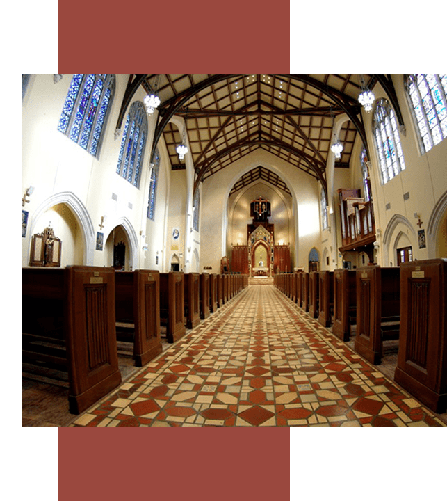 Wide angle view of the inside of a church from the aisle