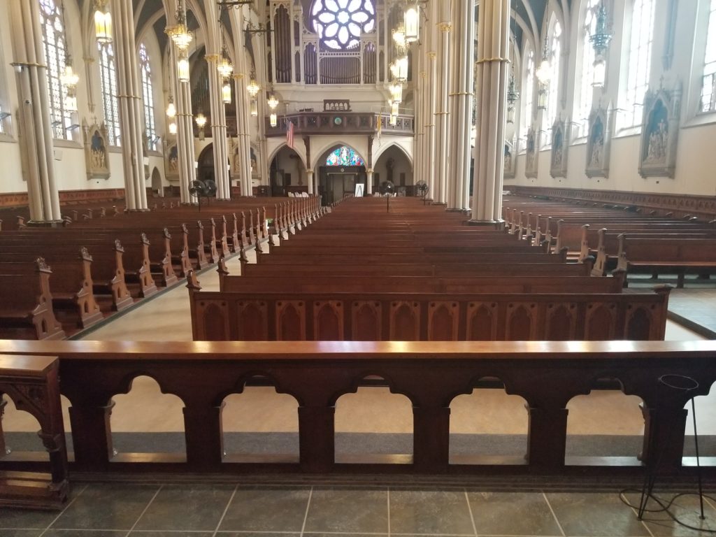 Our Lady of Grace Church altar with rows of refinished wooden pews