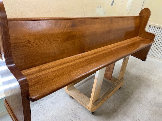 refinished wooden pew from pew restoration project at St. Rose Church