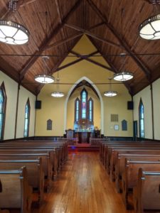 St. Stephen's Episcopal Church altar with rows of refinished wooden pews