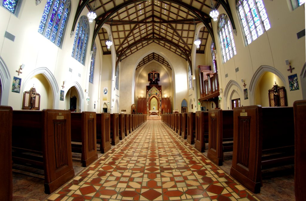 Wide angle view of the inside of a church from the aisle