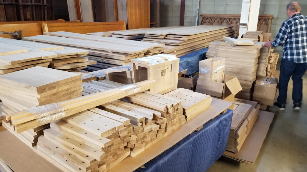 Piles of unfinished wood for building church pews